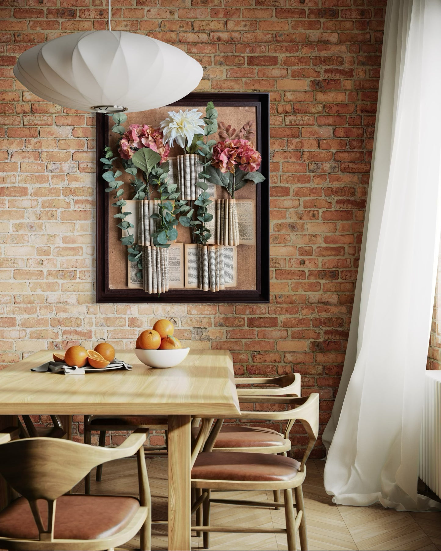 Nature-inspired wall art featuring upcycled books and faux florals in a rustic wooden frame