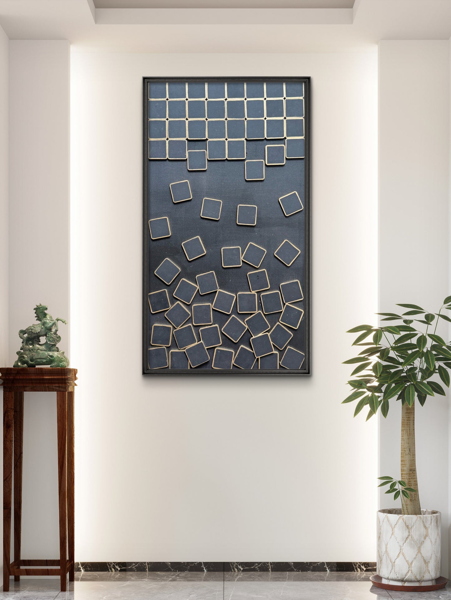 Decorative wall art with geometric design on a white wall, flanked by a wooden side table and a potted plant.