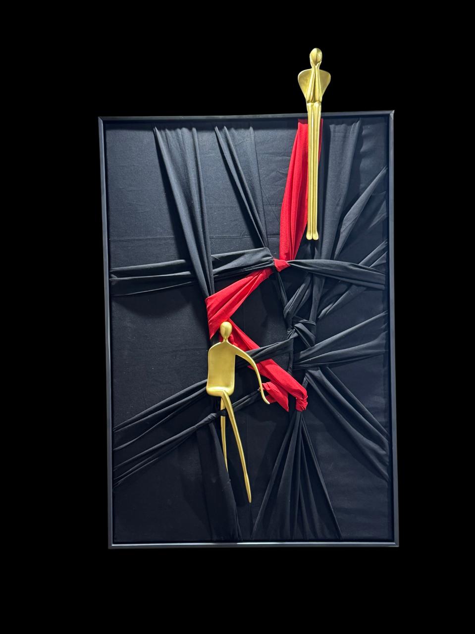 Abstract wall art of two golden figures connected by a red cloth, symbolising love and emotional connection