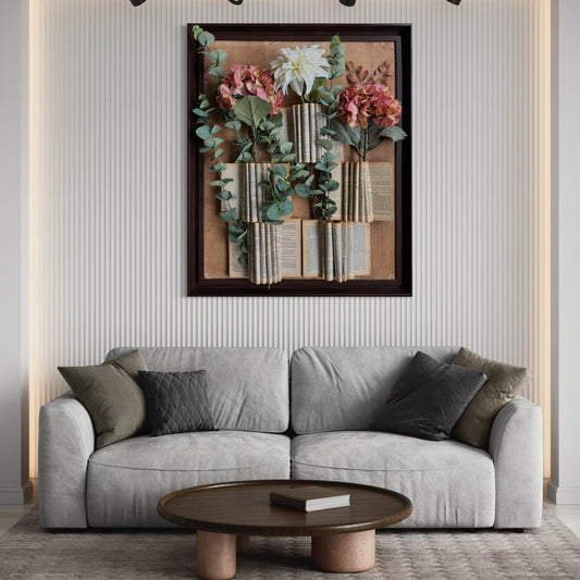 Handcrafted wall art made with vintage book pages, faux eucalyptus, and fabric flowers in a wooden frame