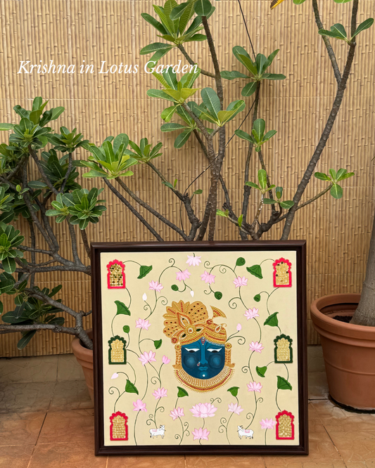 Hand-painted artwork of Lord Krishna’s face in blue with golden embellishments, surrounded by blooming pink lotus flowers, sacred cows, and decorative jaali window designs on a beige background.