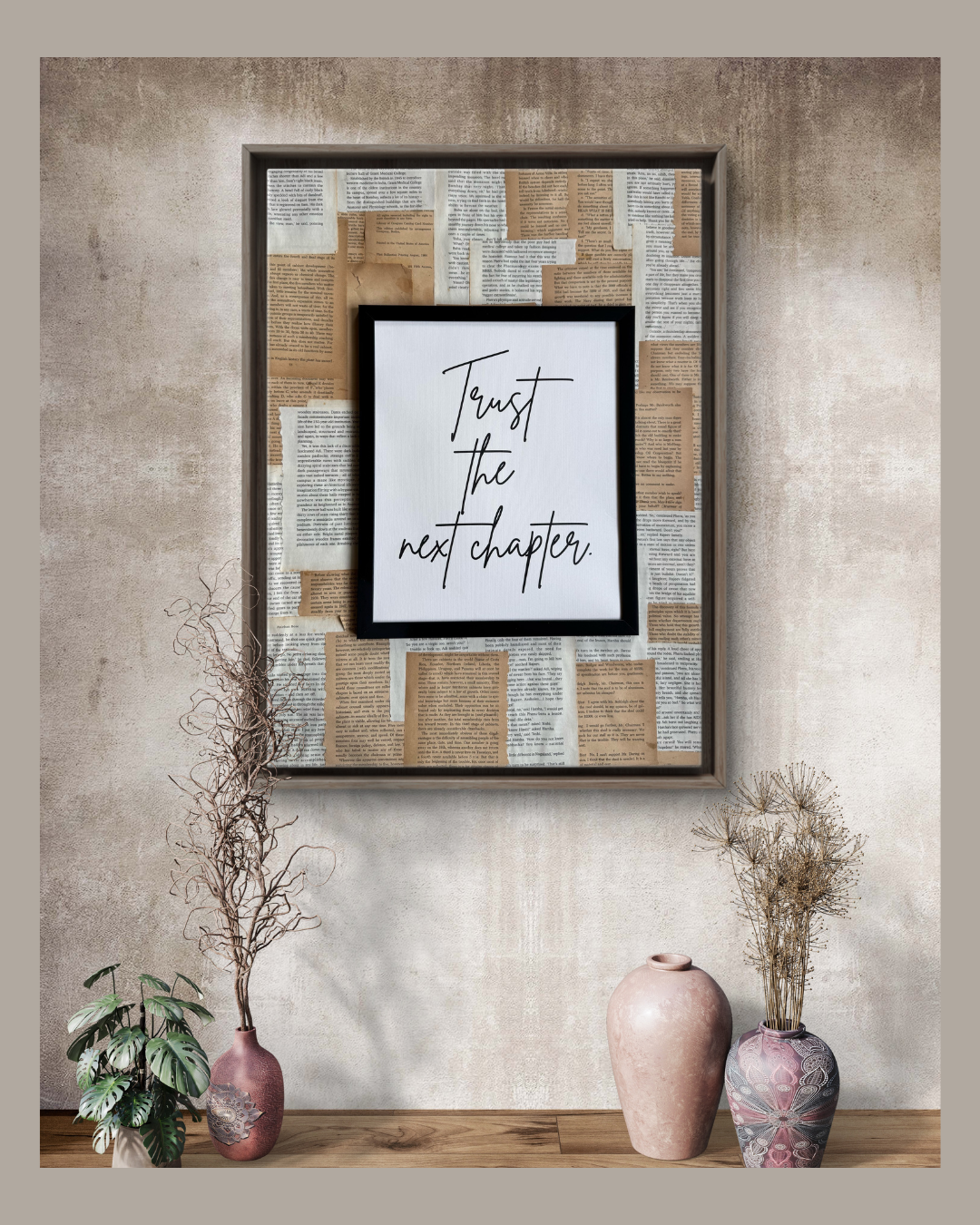 Framed wall art with the quote “Trust the next chapter” over a collage of vintage book pages.