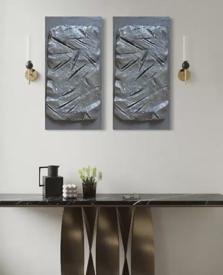 Modern sculptural textured artwork featuring a raw stone-inspired surface with carved linear details in earthy grey tones, designed as a bold contemporary statement piece for luxury interiors.